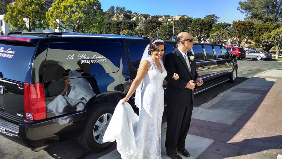 bride and groom with escalade limo ready to enter church