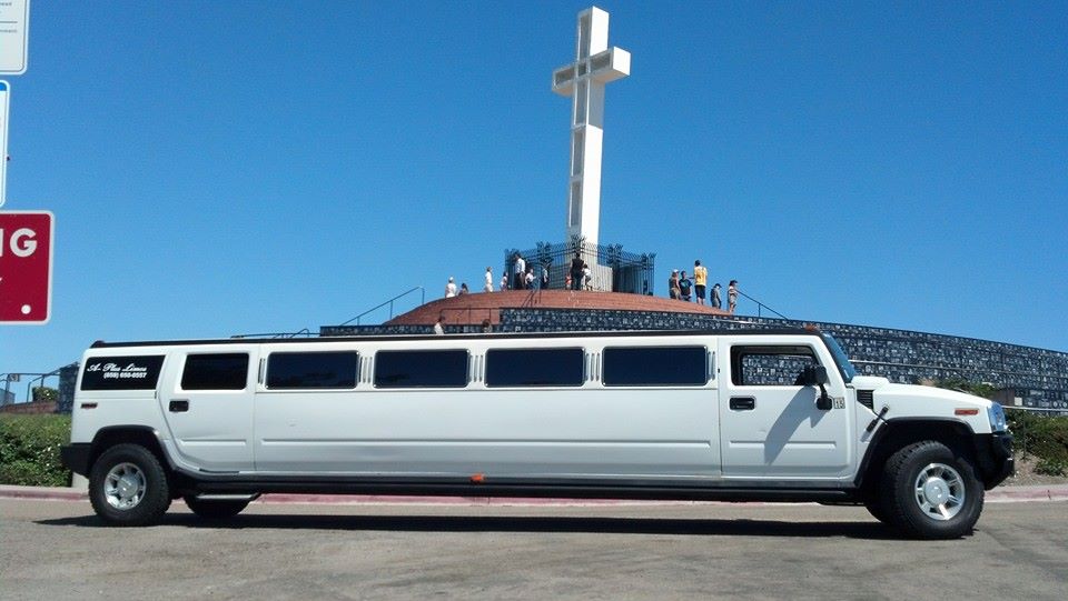 white hummer limo on top of Mt. Solidad with large cross in the background