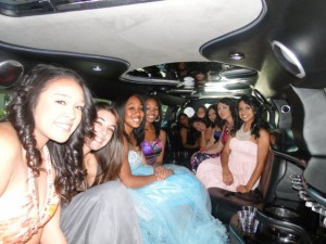 ten young women in formal wear from San Diego High School in Escalade limo going to prom