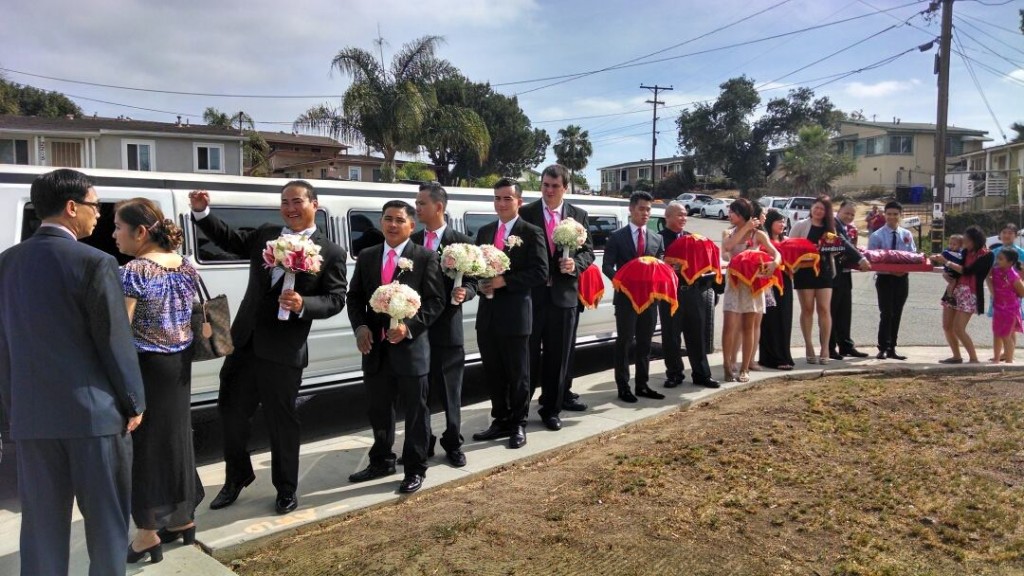 large viet american family prepares for a wedding with a plus limos
