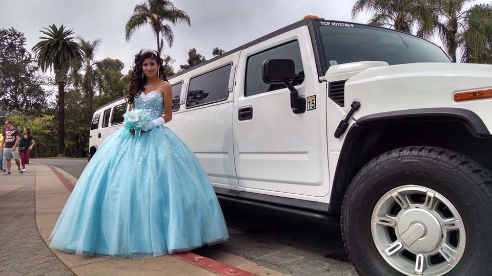 teen woman in blue dress standing with white limousine