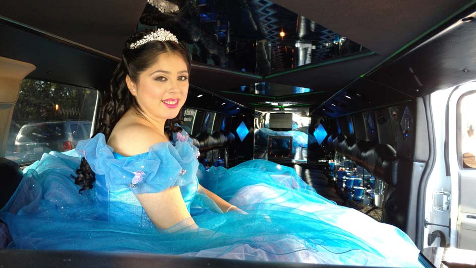 young woman wearing a blue formal gown inside a hummer limousine