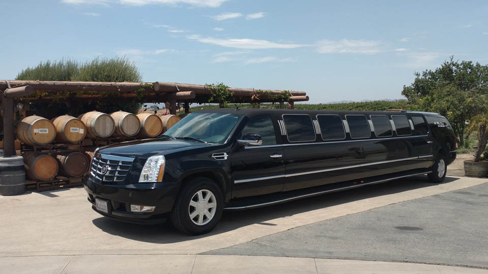 limousine in temecula winery next to wine barrels