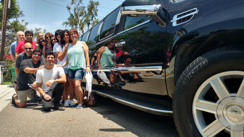 group of friends outside of limousine in route to temecula california wine country
