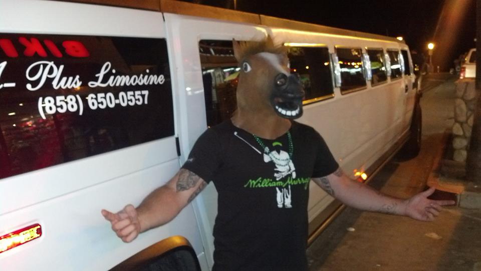 Bachelor with horse head mask standing next to hummer limo