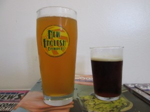 a pint glass filled with beer and a taster glass filled with beer