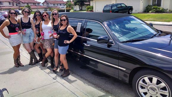 six women outside a black lincoln limo from a plus limos