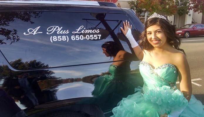 Young latina standing next to a limo