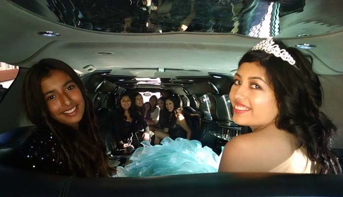 several young women in Escalade limousine