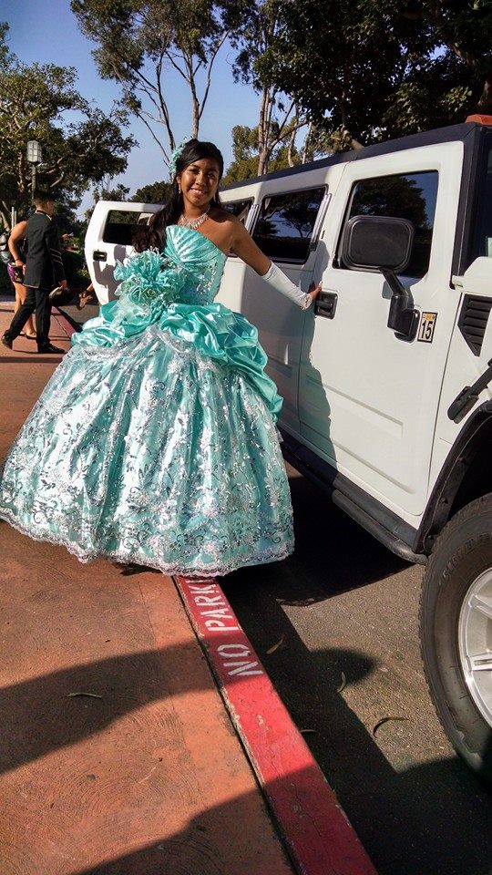 young woman in formal gown on her 15th birthday with limousine