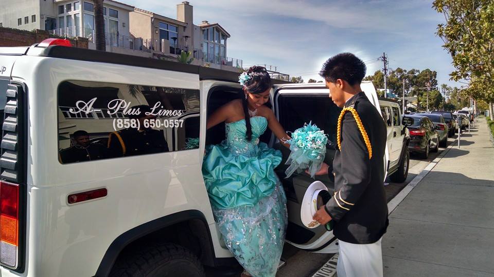 young woman in formal gown getting out of limousine