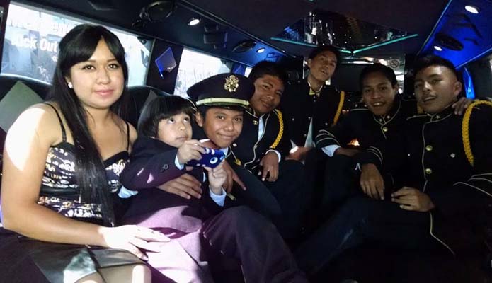 five teenagers in limo celebrating quinceanera