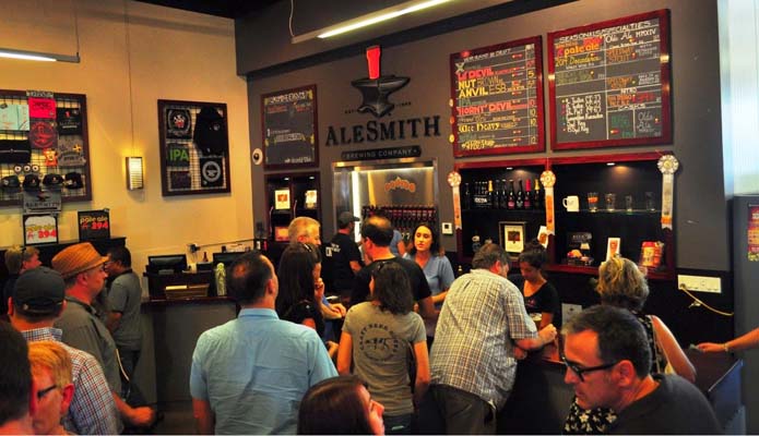 patrons line up at bar to get tastings of beer