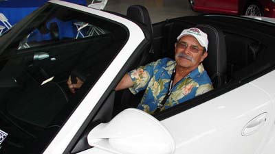 man in white Porsche convertible