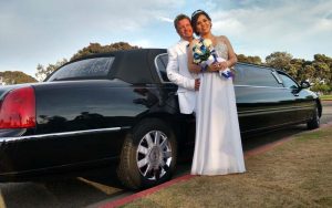 beach bums get married with black limousine